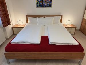 a bedroom with a large bed with two night stands at Die Trauminsel 3 in Lindau