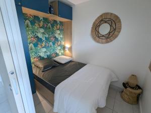 - une petite chambre avec un lit orné d'une fresque murale dans l'établissement Sol-y-Days Grand Large, front de mer vue panoramique jardins et mer, au Grau-du-Roi