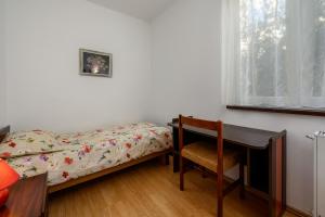 a bedroom with a bed and a desk and a chair at Apartment Luciana in Umag