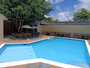 a large blue swimming pool next to a building at AMAZONAS EXPLORERS LETICIA in Leticia