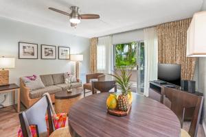 a living room with a dining table and a living room at "Island Time" at Plantation Hale D4 in Kapaa