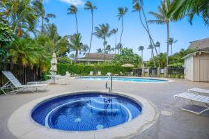 a large swimming pool with a blue swimming pool at "Island Time" at Plantation Hale D4 in Kapaa