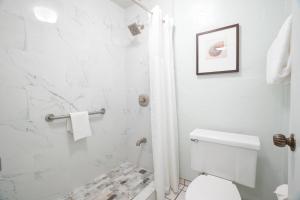 a white bathroom with a toilet and a shower at "Island Time" at Plantation Hale D4 in Kapaa +29 photos