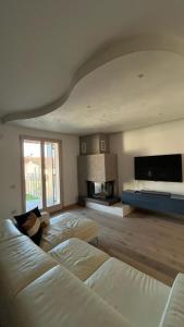 a large room with two beds and a flat screen tv at Caramaschi Verona Apartment in Negrar +14 photos