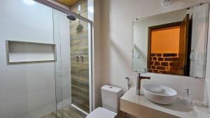 a bathroom with a sink and a toilet and a shower at Recanto da Susanne in Resende +44 photos