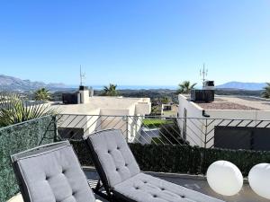 two chairs sitting on the roof of a building at Mar y montaña Tu Casa Ideal in Polop