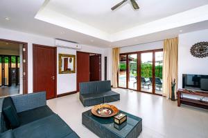 a living room with a couch and a tv at Villa SALSA PRIVATE POOL in Ko Yao Noi