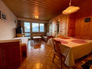 a bedroom with a bed and a table in a room at Studio Valaisia 44a in Nendaz