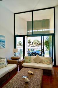 a living room with a couch and a table at Casa Binimel-là con piscina a Cala n'Bosh Menorca in Cala en Bosc +23 photos
