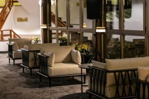 a lobby with couches and chairs and a tv at Hotel Euroski Mountain Resort & Spa in Soldeu