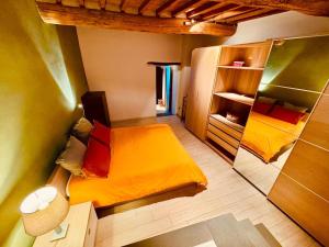 a small room with a bed and a mirror at Margherita's Home in Chianti in San Donato in Poggio