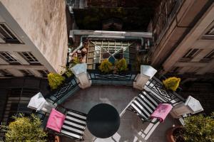 an overhead view of a balcony with chairs and a table at L'Hôtel in Paris