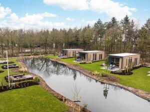 an aerial view of a resort with a river at Veluwepark De Bosgraaf | Luxe & Wellness in Lieren +15 photos