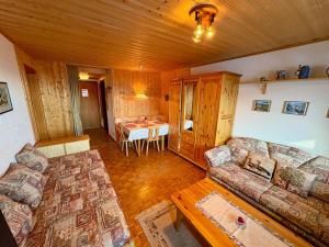 a living room with a couch and a table at Studio Valaisia 45a in Nendaz