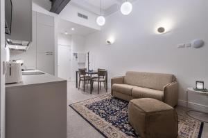 a living room with a couch and a table at Old Theatre Suites - Tremiti in Valletta