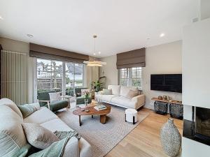 a living room with a couch and a table at Villa Charme - Koksijde in Koksijde