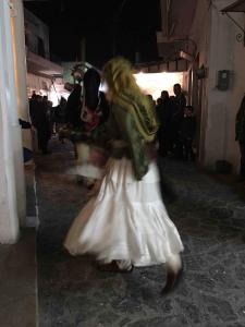 a woman in a white dress and a cow at Amerissas studios 3 in Skiros