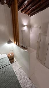 a white room with a bed and a bathroom at Amerissas studios 3 in Skiros +69 photos