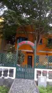 an orange building with a green fence in front of it at Aldeia Jerome in Paul