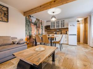 a living room with a couch and a table at Słoneczna Wetlina - Apartament 2 z kominkiem in Wetlina