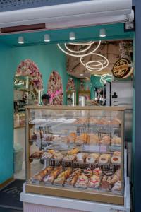 a bakery display case filled with lots of donuts at Iodis Relais in Naples