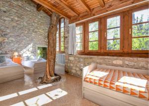 a bedroom with two beds and a tree in it at Le Ravere Luxury Mini-Resort - a structure for 12 in Gargnano +52 photos