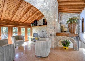 a living room with a stone wall and a fireplace at Le Ravere Luxury Mini-Resort - a structure for 12 in Gargnano