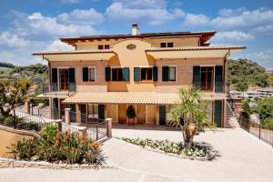 a large house with a courtyard in front of it at Residenza Marano in Cupra Marittima