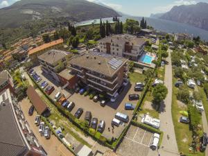 an aerial view of a town with cars parked in a parking lot at Hotel Garnì Villa Magnolia in Nago-Torbole