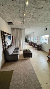 a living room with a couch and a table at Viva sol hospedagem in Cabo Frio