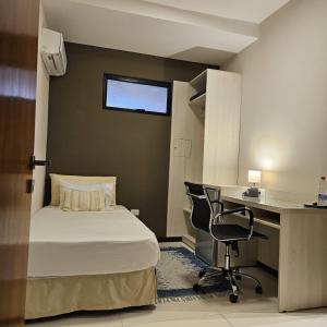 a bedroom with a bed and a desk and a chair at Casa Garay Hotel 658 in Asuncion