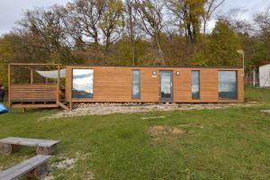 a modular home in a field with a picnic bench at Arktik in Bojnice