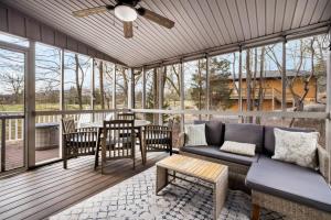 a screened in porch with a couch and a table at Golf Views Fireplace 2 Fire Pits Grill & Deck in Hedgesville