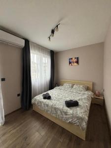 a bedroom with a bed with a bird on the ceiling at GRAND APARTMENT OHRID - top center near to sea and sea garden in Burgas City