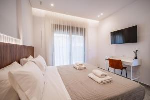 A bed or beds in a room at Margiani Studio & Apartment