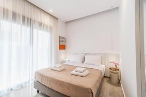 A bed or beds in a room at Margiani Studio & Apartment