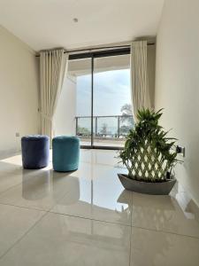 a room with two blue chairs and a large window at Pearly Ocean View Suite in Dehiwala