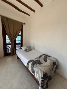 Postel nebo postele na pokoji v ubytování Hotel Mittoz Holbox