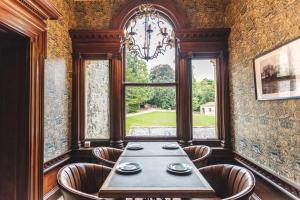 a dining room with a table and a window at The Chapel Suite in Marske