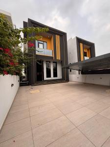 a large house with a large patio in front of it at Jaiye Villa in Lekki