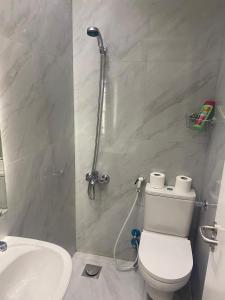 a bathroom with a toilet and a sink at Nile Inn 503 Cozy Studio Steps Away From the Nile in Cairo +27 photos