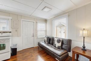 a living room with a leather couch and a table at Starfish 2 in Rockaway Beach