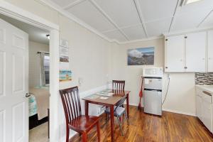 a kitchen with a table and chairs and a refrigerator at Starfish 2 in Rockaway Beach