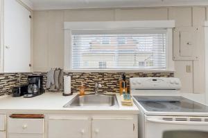 a kitchen with a sink and a stove and a window at Starfish 2 in Rockaway Beach +19 photos