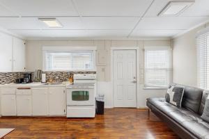 a living room with a couch and a kitchen at Starfish 2 in Rockaway Beach