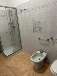 a bathroom with a shower and a toilet and a sink at Locanda San Martino in Collecchio +8 photos