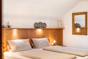 a bedroom with two beds and a mirror at Ferienhaus Frühholz - Waxenstein in Grainau