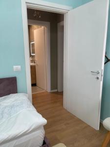 a bedroom with a door open to a room with a bed at Garden Building Luxury Apartment in Tirana