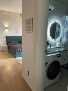 a bathroom with a washing machine in a room at Garden Building Luxury Apartment in Tirana