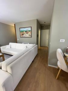 a living room with two white couches at Garden Building Luxury Apartment in Tirana